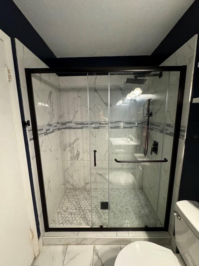 106 Pendley St, Sylvester, GA 31791 - full bathroom featuring a shower stall, marble finish floor, a textured ceiling, and toilet