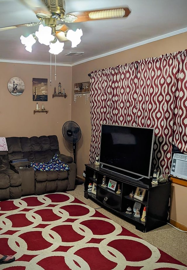 carpeted living room with crown molding, visible vents, and a ceiling fan
