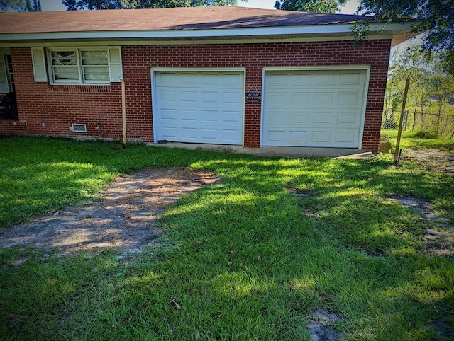 garage with driveway and fence