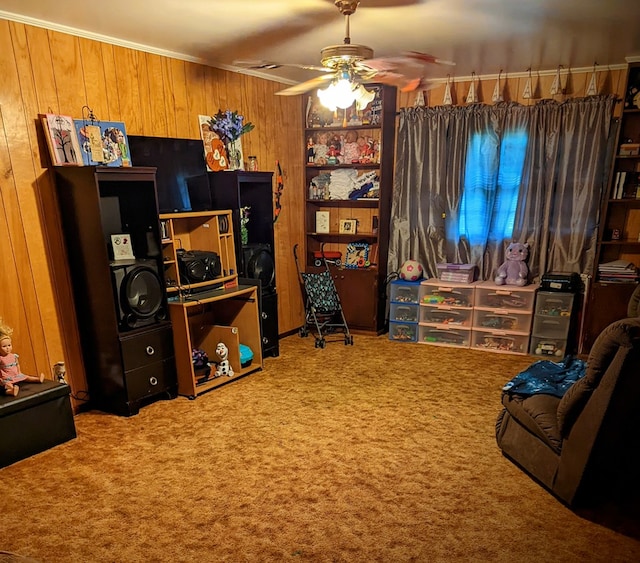 carpeted office space with crown molding, wooden walls, and a ceiling fan