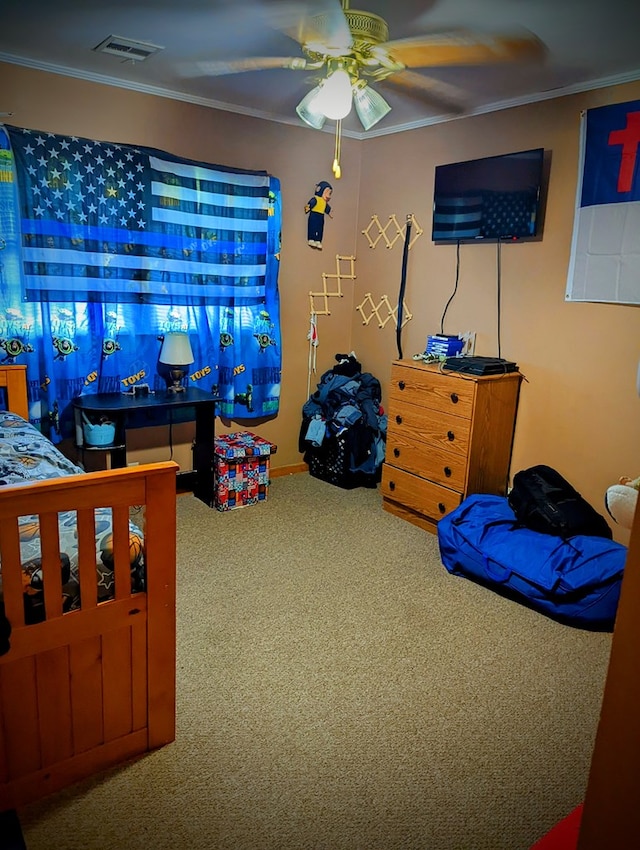 carpeted bedroom featuring ornamental molding, visible vents, and a ceiling fan