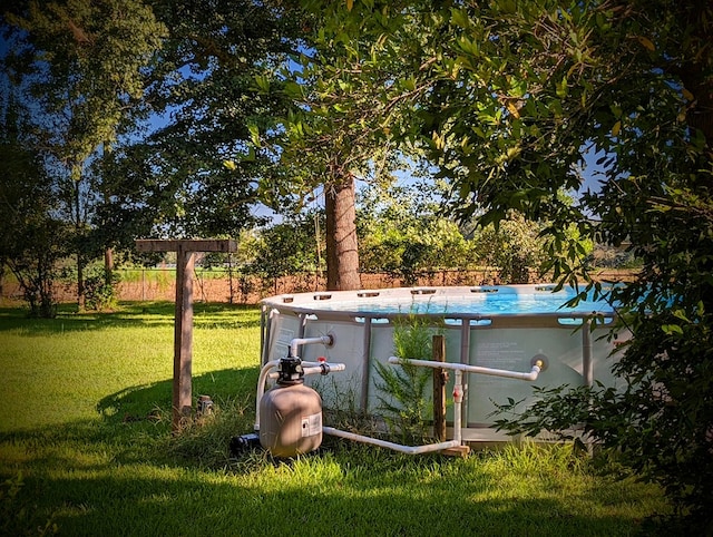 view of yard featuring an outdoor pool and fence