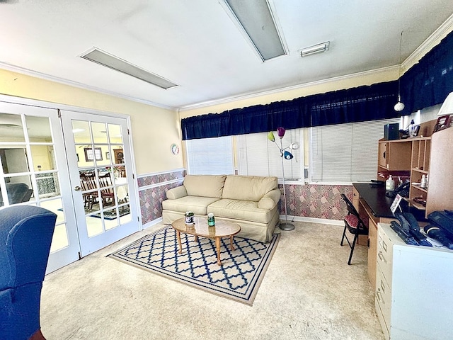living area featuring crown molding, a wainscoted wall, baseboards, and wallpapered walls