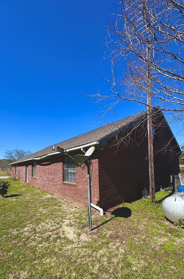 exterior space with a yard and brick siding