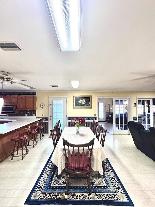 dining space featuring a ceiling fan and visible vents