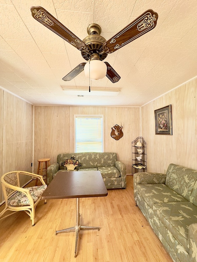 living room featuring a ceiling fan and wood finished floors