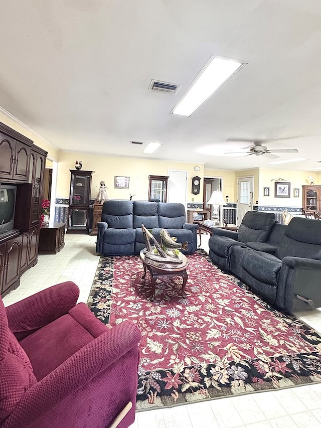 living room with visible vents and a ceiling fan