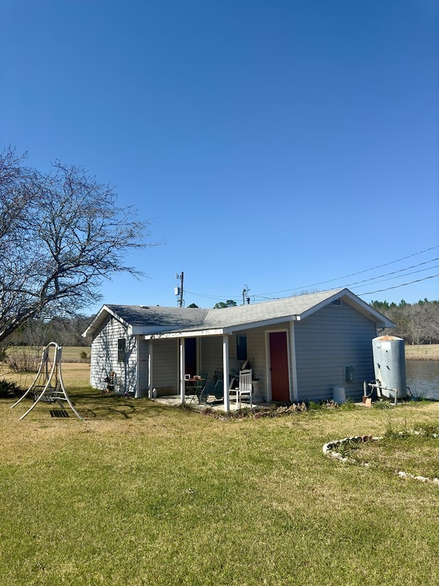 back of property featuring a yard