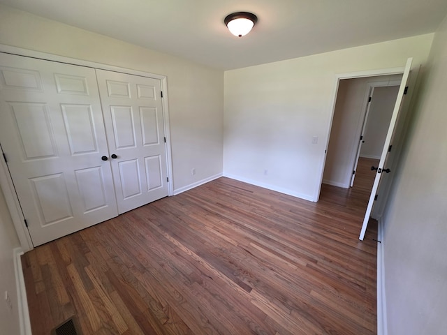 124 N Main St, Fitzgerald, GA 31750 - unfurnished bedroom with wood finished floors and a closet