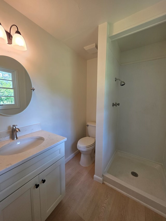 124 N Main St, Fitzgerald, GA 31750 - full bath featuring wood finished floors, vanity, and a shower