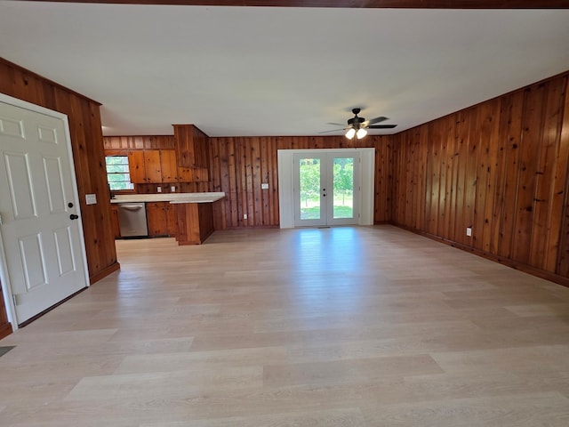 124 N Main St, Fitzgerald, GA 31750 - kitchen with brown cabinetry, dishwasher, open floor plan, a ceiling fan, and light wood-style flooring