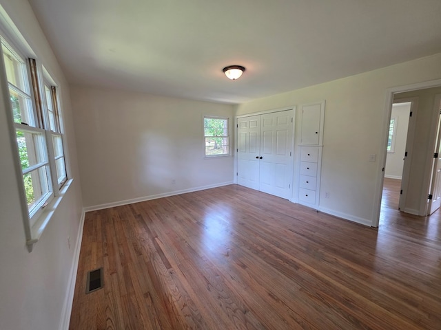 124 N Main St, Fitzgerald, GA 31750 - unfurnished bedroom featuring wood finished floors and a closet