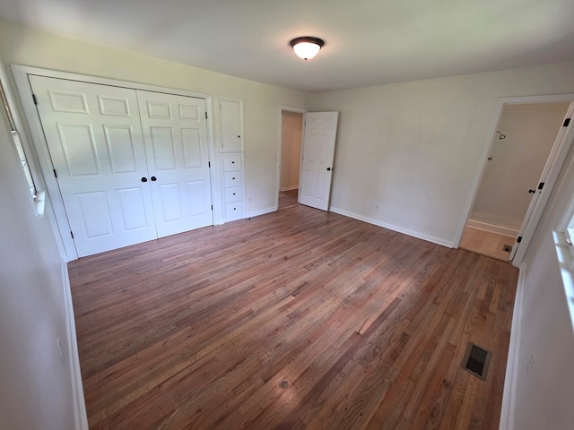 124 N Main St, Fitzgerald, GA 31750 - unfurnished bedroom with wood finished floors and a closet