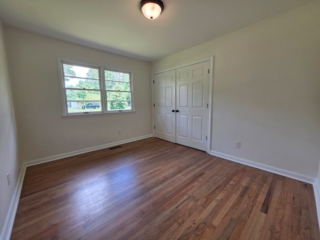 124 N Main St, Fitzgerald, GA 31750 - unfurnished bedroom with wood finished floors and a closet