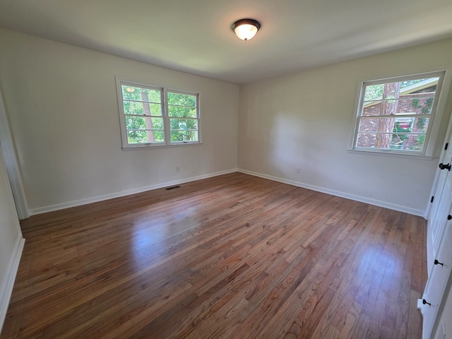 124 N Main St, Fitzgerald, GA 31750 - spare room with wood finished floors and healthy amount of natural light