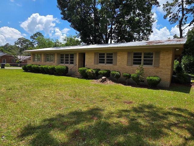 124 N Main St, Fitzgerald, GA 31750 - single story home featuring a front lawn, brick siding, and a metal roof