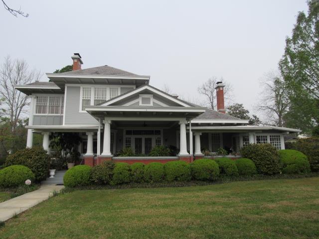 back of property featuring a yard and a chimney