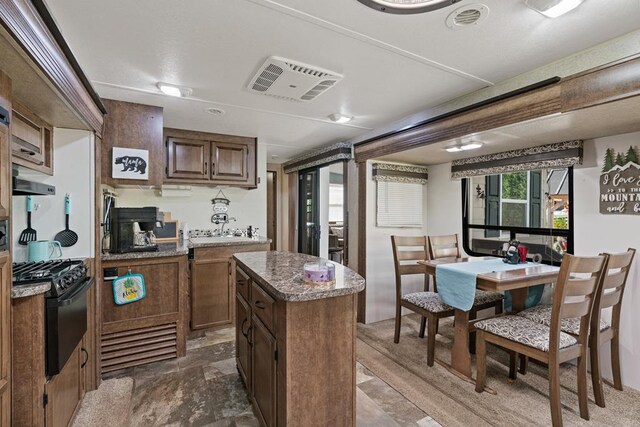 28 Bear Lovers Ct, Cleveland, GA 30528 - kitchen with visible vents, a center island, and black range with gas cooktop
