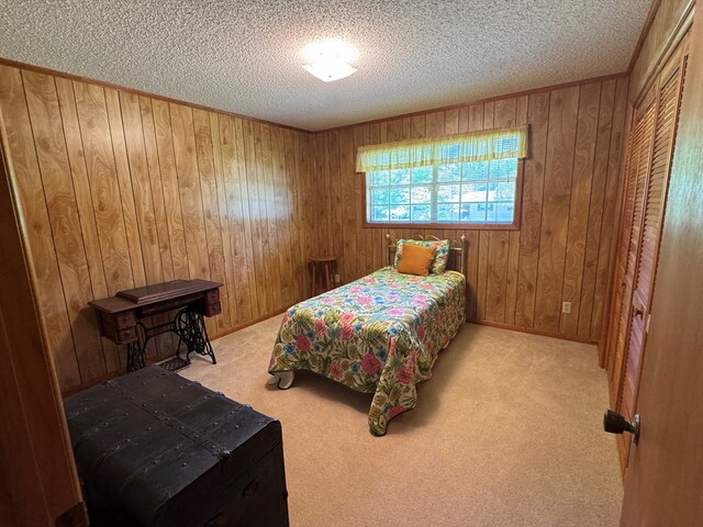 142 Elva Cir, Enigma, GA 31749 - bedroom featuring a textured ceiling, wooden walls, carpet, and baseboards