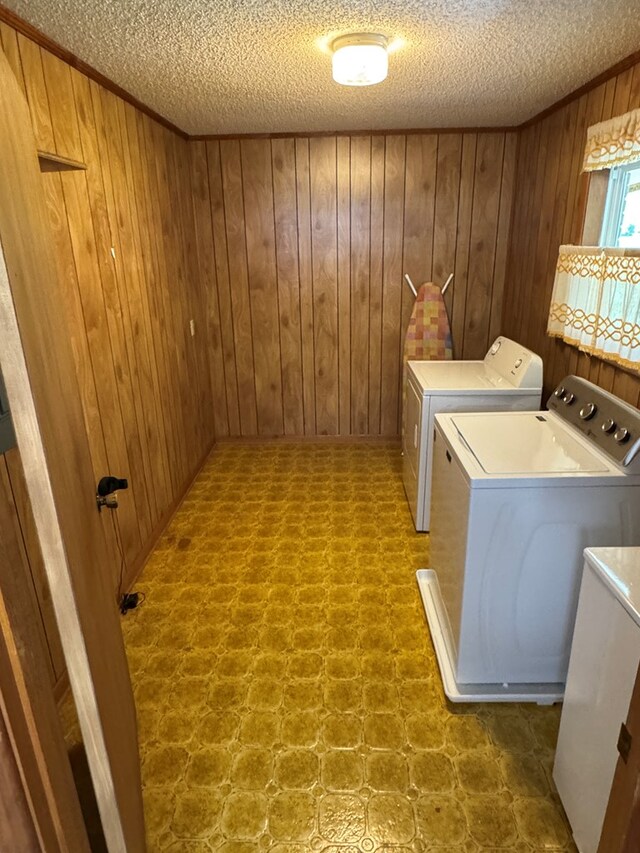 142 Elva Cir, Enigma, GA 31749 - laundry room featuring washer and dryer, wooden walls, a textured ceiling, and tile patterned floors