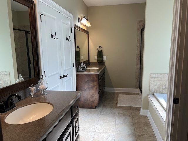 219 Cypress Ridge Rd, Tifton, GA 31794 - full bathroom featuring a shower stall, vanity, a garden tub, baseboards, and tile patterned flooring