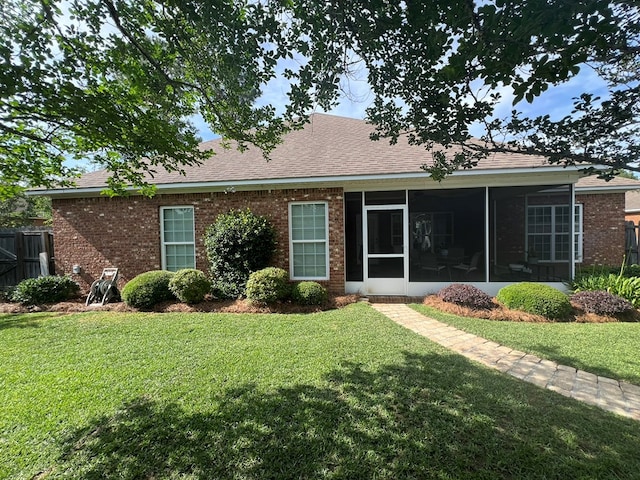 219 Cypress Ridge Rd, Tifton, GA 31794 - back of property with a sunroom, brick siding, and roof with shingles