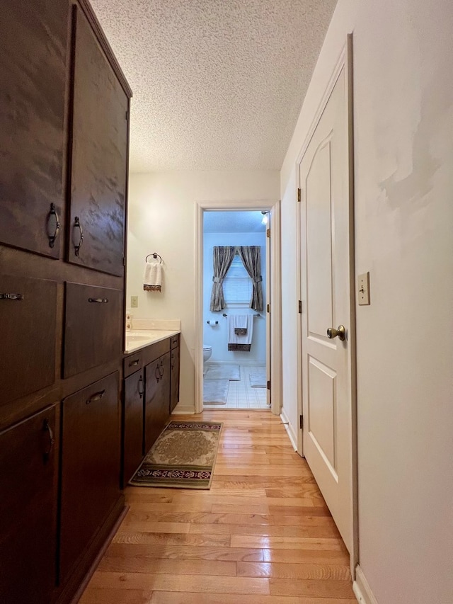 109 Preston Dr, Fitzgerald, GA 31750 - bathroom with hardwood / wood-style flooring, a textured ceiling, toilet, vanity, and baseboards