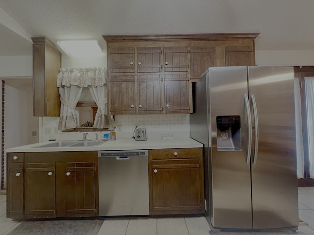 109 Preston Dr, Fitzgerald, GA 31750 - kitchen featuring appliances with stainless steel finishes, a sink, light tile patterned flooring, and light countertops