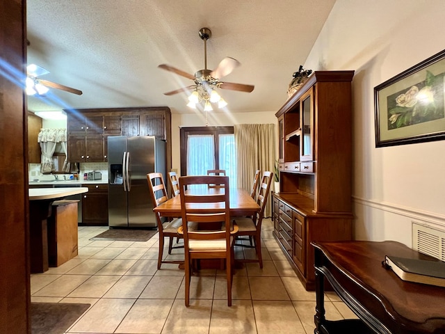 109 Preston Dr, Fitzgerald, GA 31750 - dining space with a ceiling fan, light tile patterned flooring, and a textured ceiling