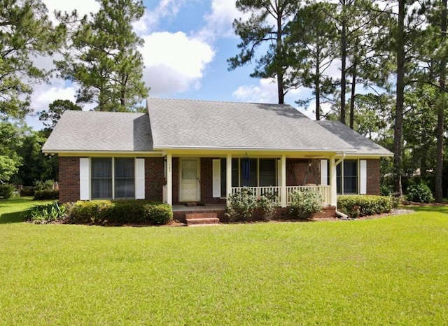 109 Preston Dr, Fitzgerald, GA 31750 - view of front of home featuring a front yard, covered porch, and brick siding