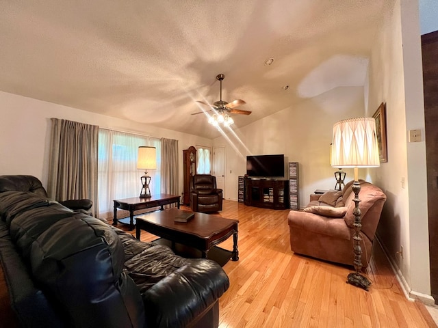 109 Preston Dr, Fitzgerald, GA 31750 - living room featuring a ceiling fan, light wood-type flooring, baseboards, lofted ceiling, and a textured ceiling