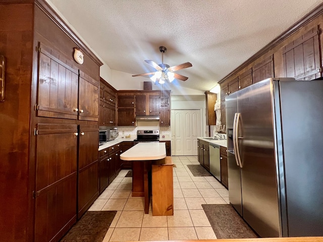 109 Preston Dr, Fitzgerald, GA 31750 - kitchen featuring appliances with stainless steel finishes, a center island, vaulted ceiling, light countertops, and ceiling fan