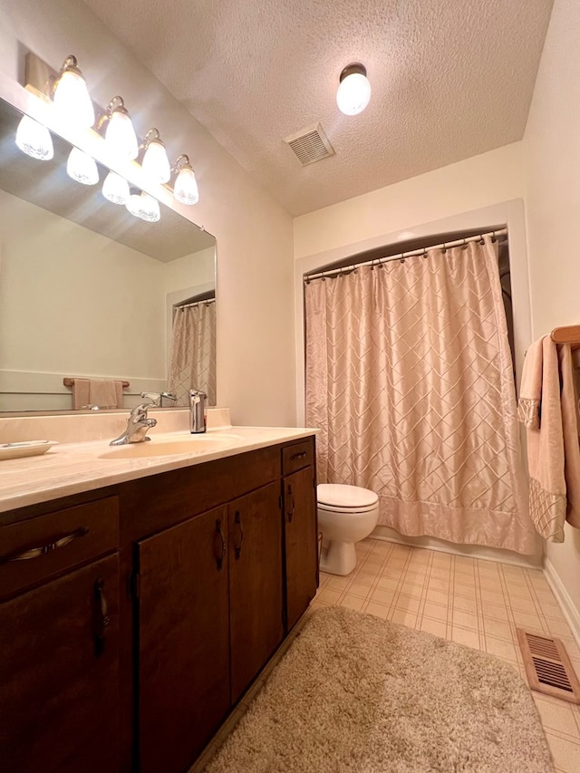 109 Preston Dr, Fitzgerald, GA 31750 - bathroom with toilet, vanity, and a textured ceiling