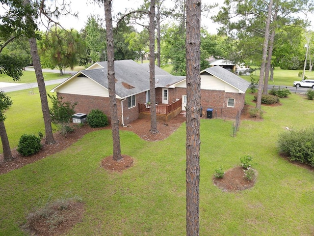 109 Preston Dr, Fitzgerald, GA 31750 - view of property exterior with brick siding, a yard, a deck, and view of scattered trees