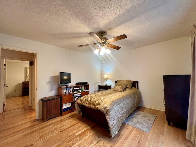 109 Preston Dr, Fitzgerald, GA 31750 - bedroom with light wood-style floors, a textured ceiling, baseboards, and ceiling fan