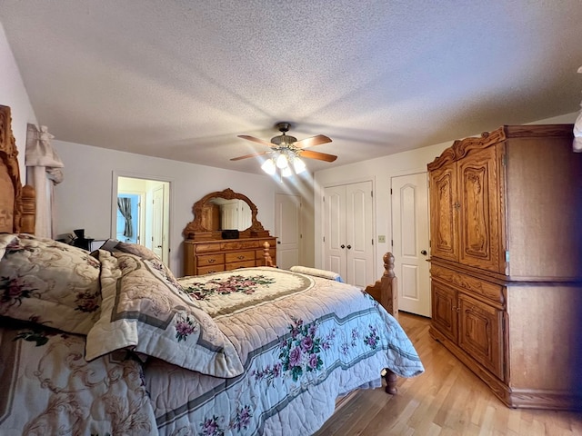 109 Preston Dr, Fitzgerald, GA 31750 - bedroom featuring light wood-type flooring, a textured ceiling, two closets, and ceiling fan