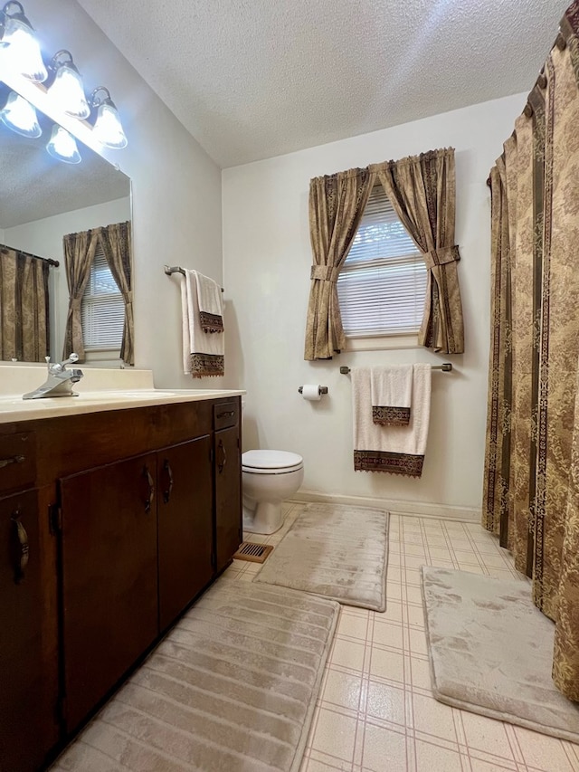 109 Preston Dr, Fitzgerald, GA 31750 - full bath with toilet, vanity, a textured ceiling, and tile patterned floors
