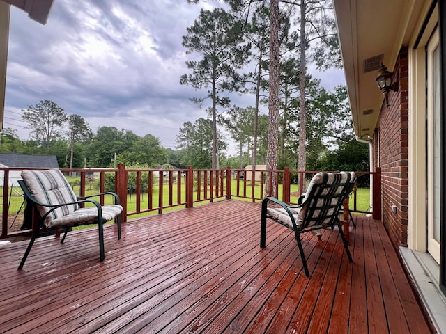 109 Preston Dr, Fitzgerald, GA 31750 - wooden deck featuring view of wooded area