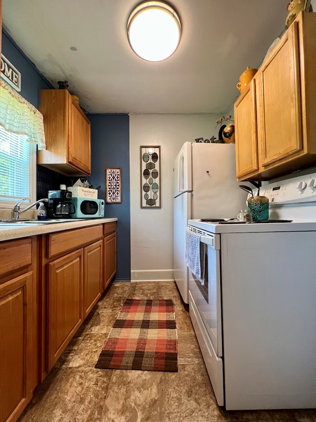 116 Branch Dr, Fitzgerald, GA 31750 - kitchen with white electric range oven, light countertops, and brown cabinets