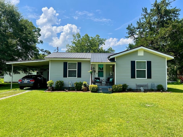 116 Branch Dr, Fitzgerald, GA 31750 - view of front of property featuring covered porch, a front yard, an attached carport, and a metal roof
