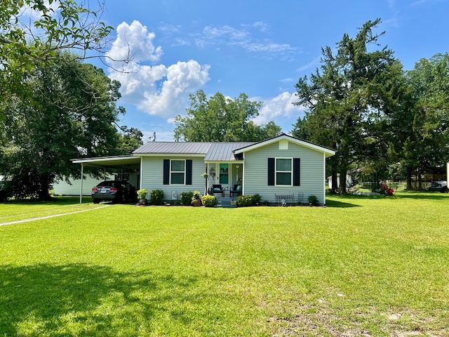 116 Branch Dr, Fitzgerald, GA 31750 - view of front facade featuring covered porch, a carport, a front lawn, and a metal roof