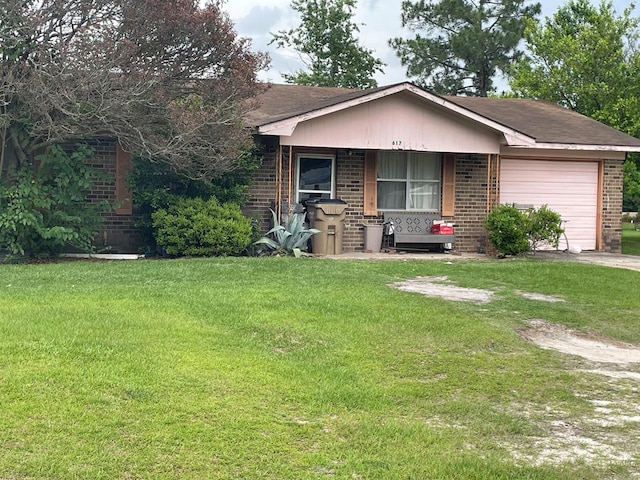 617 N Fieldstone, Ocilla, GA 31774 - view of front of house featuring a front lawn, an attached garage, brick siding, a shingled roof, and covered porch