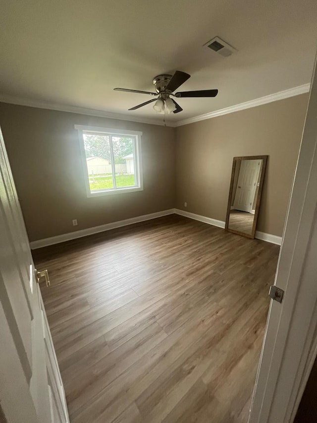 315 Newton Dr, Adel, GA 31620 - empty room with crown molding, ceiling fan, wood finished floors, and baseboards