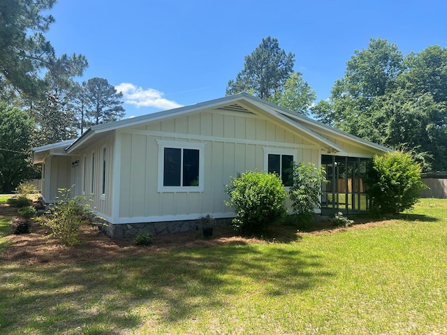 315 Newton Dr, Adel, GA 31620 - view of side of property featuring board and batten siding and a yard