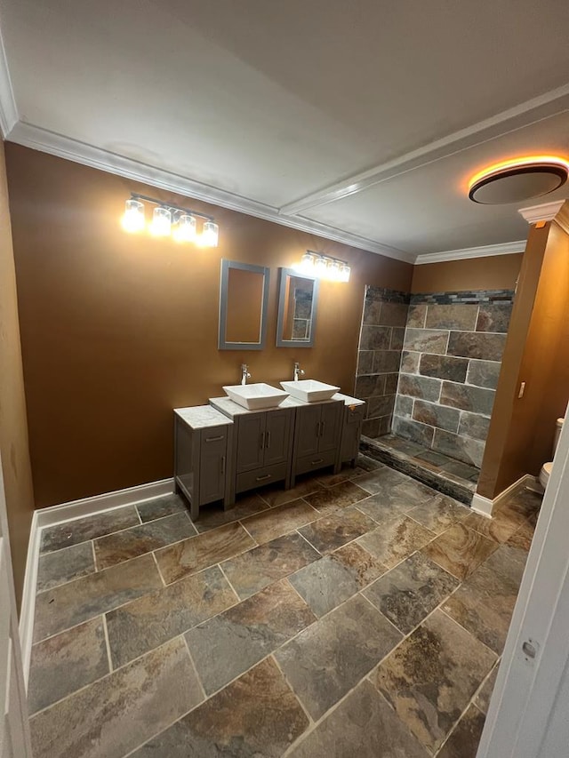 315 Newton Dr, Adel, GA 31620 - bathroom featuring stone tile flooring, tiled shower, ornamental molding, baseboards, and double vanity