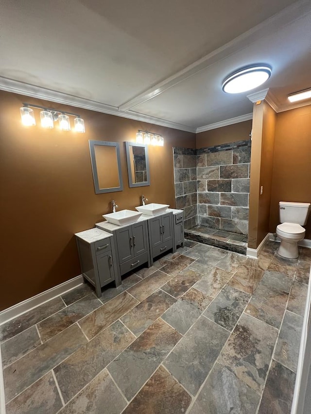 315 Newton Dr, Adel, GA 31620 - bathroom featuring stone tile flooring, a tile shower, toilet, ornamental molding, and baseboards