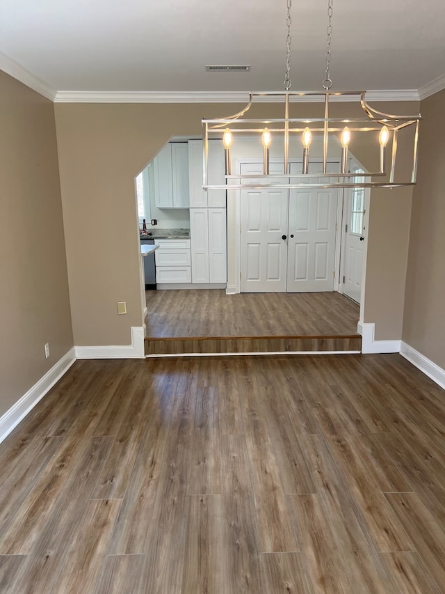 315 Newton Dr, Adel, GA 31620 - unfurnished living room featuring crown molding, baseboards, and wood finished floors