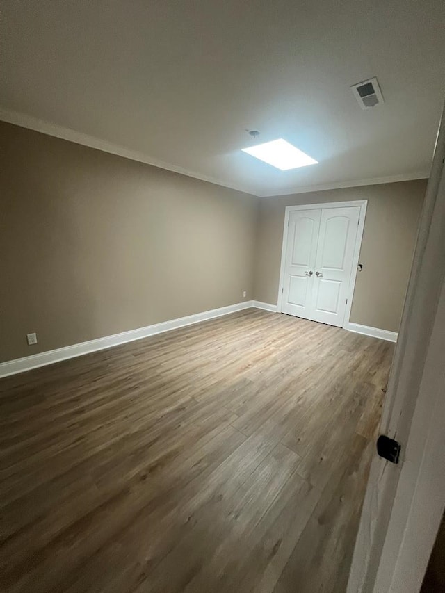 315 Newton Dr, Adel, GA 31620 - unfurnished bedroom with ornamental molding, dark wood finished floors, baseboards, and a closet