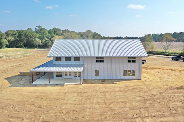 rear view of house featuring metal roof