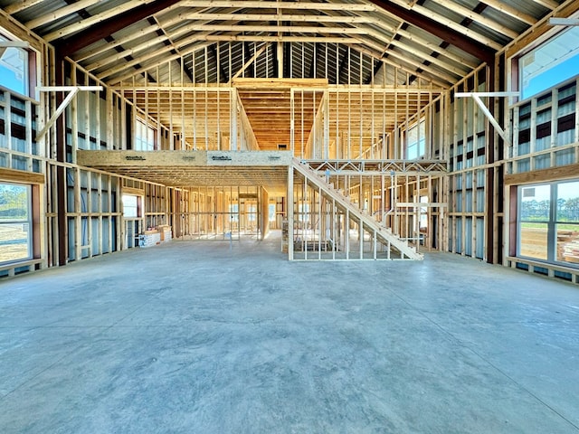 miscellaneous room featuring concrete floors and high vaulted ceiling